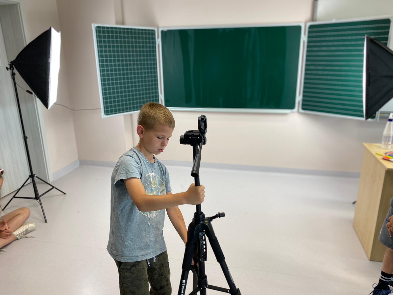 Uczeń montuje statyw do aparatu
